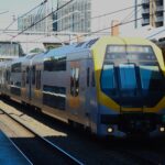 A modern city train arrives at a busy station in Sydney, Australia.
