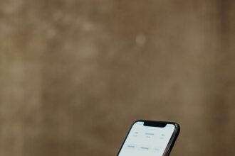 Close-up of hands using a smartphone to browse a photo gallery app, showcasing modern technology.